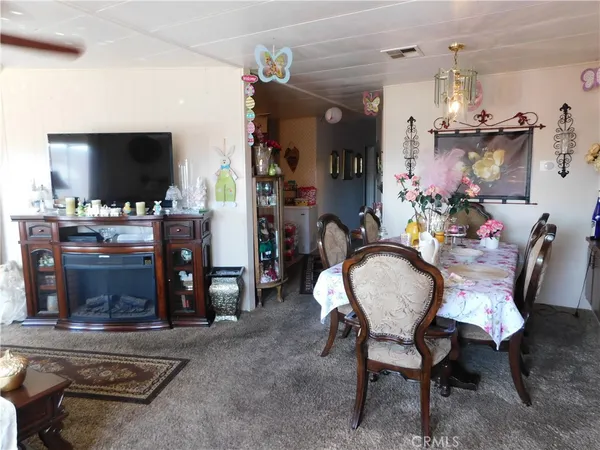 a dining room with furniture and a flat screen tv