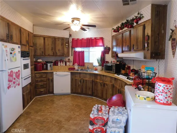 a kitchen with refrigerator and cabinets