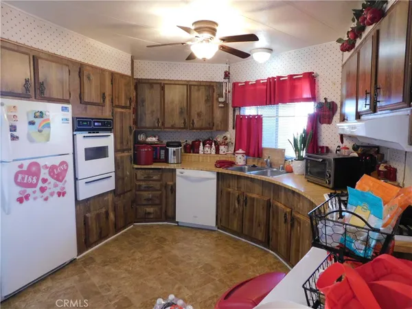 a kitchen with refrigerator and cabinets