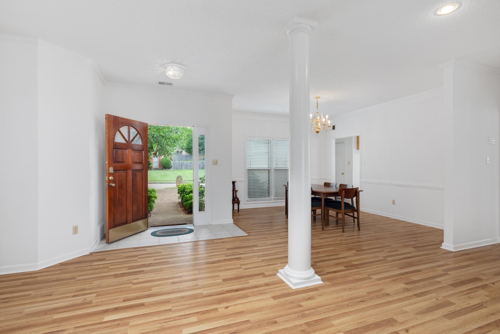 9015 Raspberry Lane Cordova, TN 38016 - Photo 4 of 40 Entrance foyer featuring light wood-type flooring, decorative columns, ornamental molding, and a notable chandelier