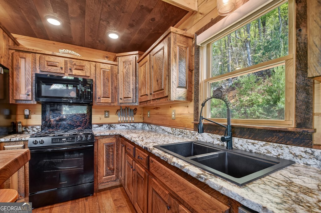 459 Quail Ridge Road Epworth, GA 30541 - Photo 13 of 73 a kitchen with a sink a stove and cabinets