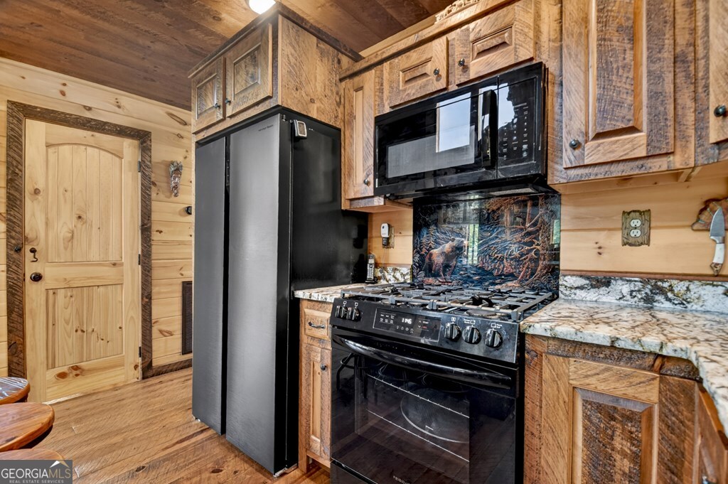 459 Quail Ridge Road Epworth, GA 30541 - Photo 32 of 73 a kitchen with stainless steel appliances granite countertop a stove microwave and cabinets