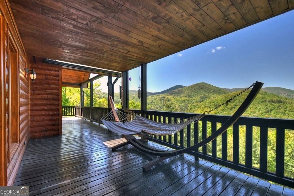 459 Quail Ridge Road Epworth, GA 30541 - Photo 38 of 73 a view of a chairs and table on the wooden roof deck
