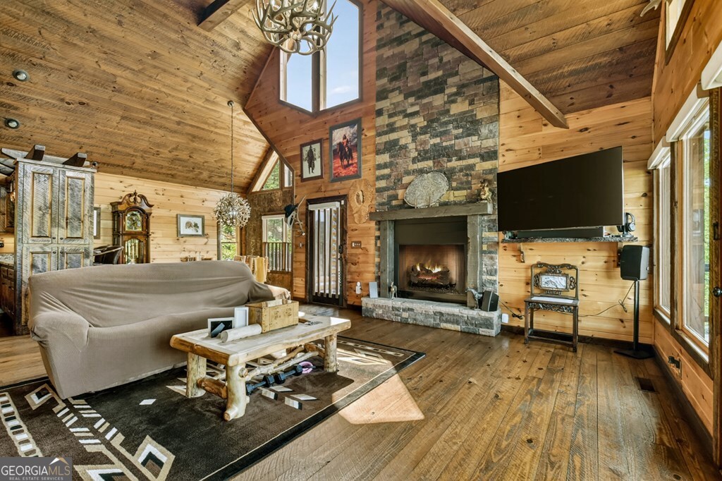 459 Quail Ridge Road Epworth, GA 30541 - Photo 10 of 73 a living room with furniture a flat screen tv and a fireplace