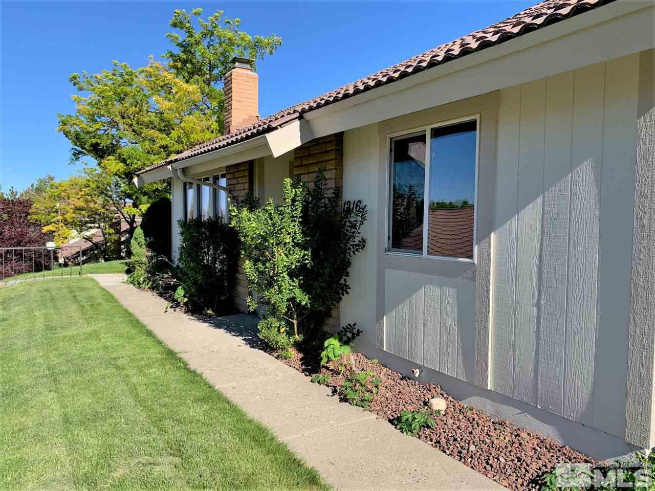 1216 Laredo Court Reno, NV 89503 - Photo 1 of 28 a front view of a house with garden