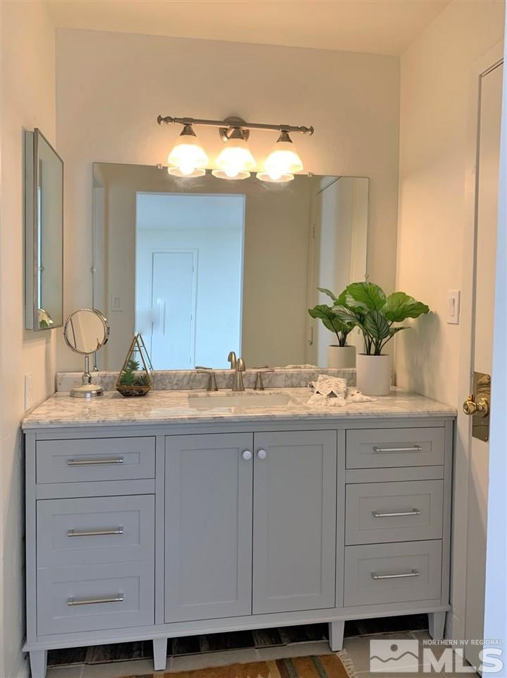 1216 Laredo Court Reno, NV 89503 - Photo 15 of 28 a bathroom with a granite countertop sink and a mirror