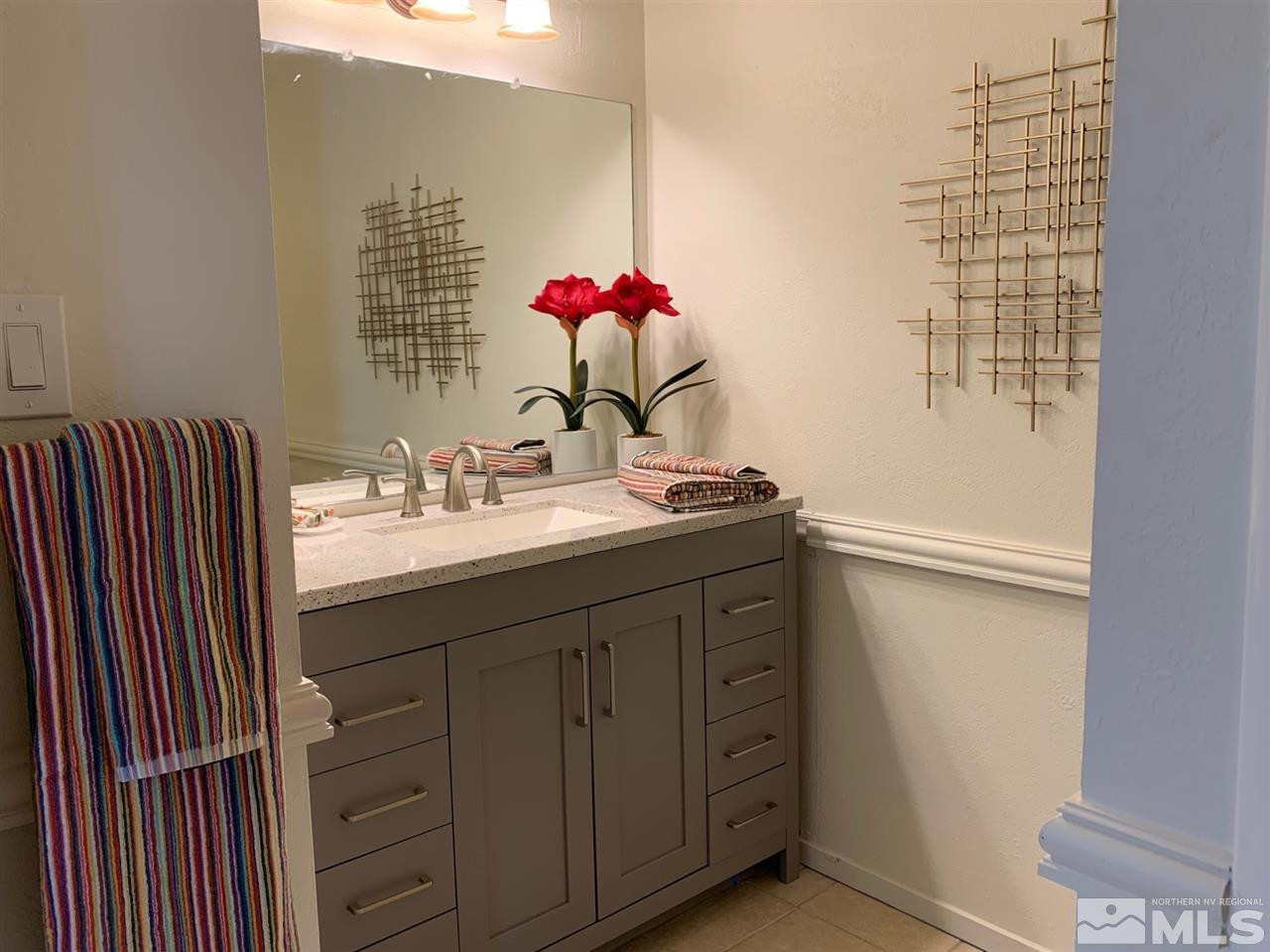 1216 Laredo Court Reno, NV 89503 - Photo 21 of 28 a bathroom with a sink vanity and a mirror