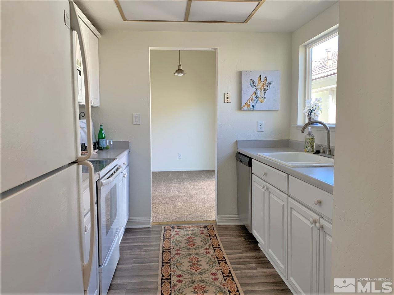 1216 Laredo Court Reno, NV 89503 - Photo 9 of 28 a bathroom with a sink a mirror and a window