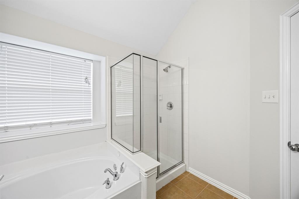 2804 Barco Grand Prairie, TX 75054 - Photo 15 of 25 a bathroom with a tub and a window