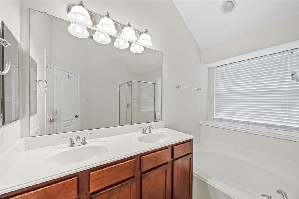 2804 Barco Grand Prairie, TX 75054 - Photo 16 of 25 a bathroom with a sink a vanity and a mirror