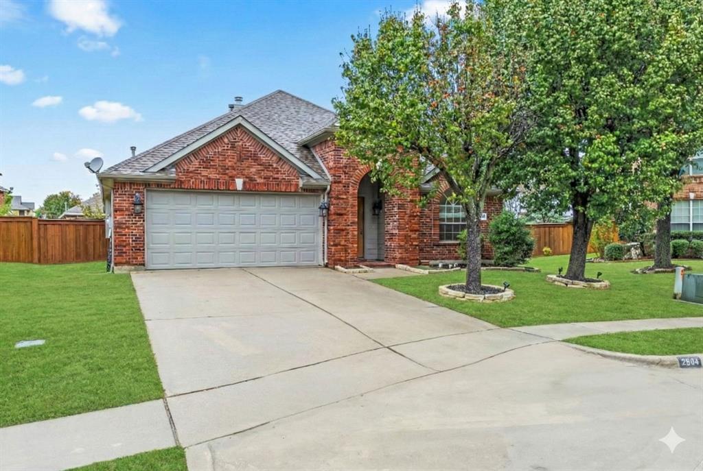 2804 Barco Grand Prairie, TX 75054 - Photo 2 of 25 a front view of a house with a garden and trees