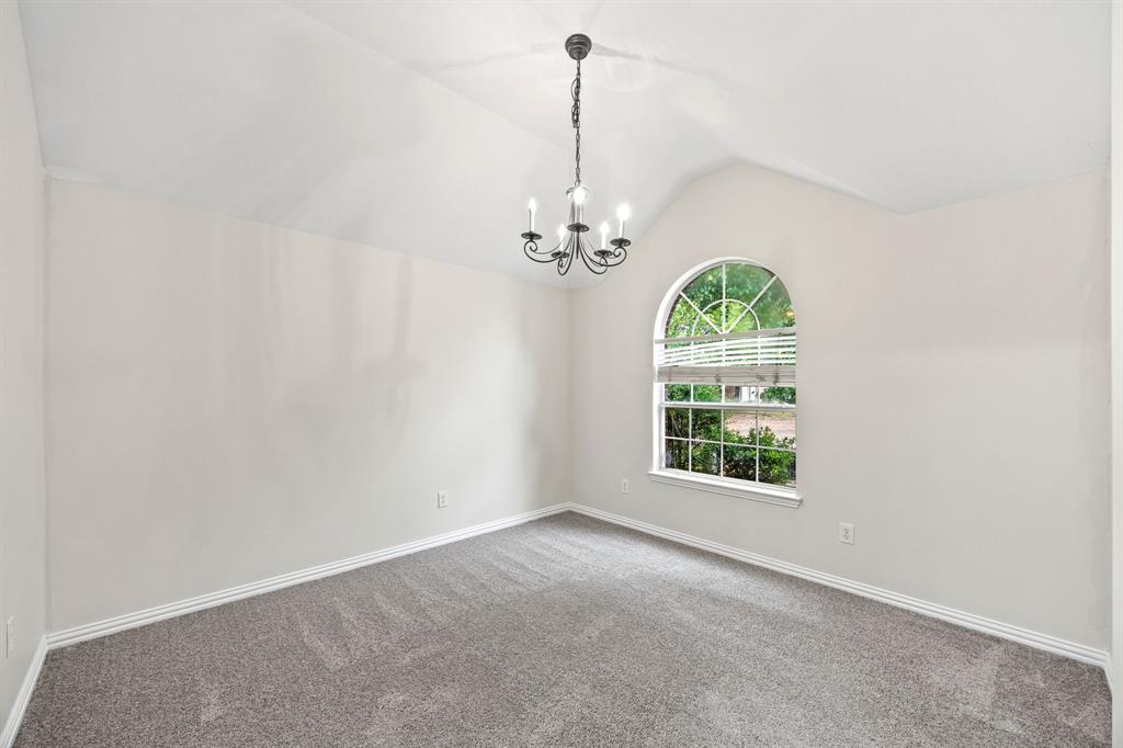 2804 Barco Grand Prairie, TX 75054 - Photo 3 of 25 en empty room with windows and chandelier