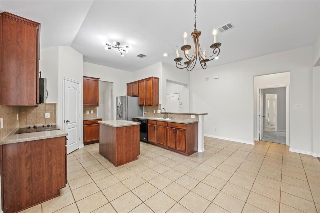 2804 Barco Grand Prairie, TX 75054 - Photo 5 of 25 a kitchen with stainless steel appliances granite countertop a refrigerator a sink dishwasher a stove and white cabinets