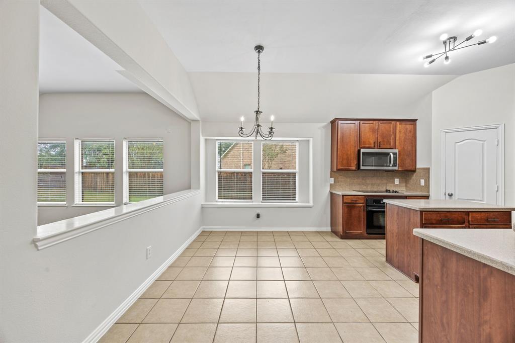 2804 Barco Grand Prairie, TX 75054 - Photo 8 of 25 a kitchen with stainless steel appliances granite countertop a stove a sink and a refrigerator