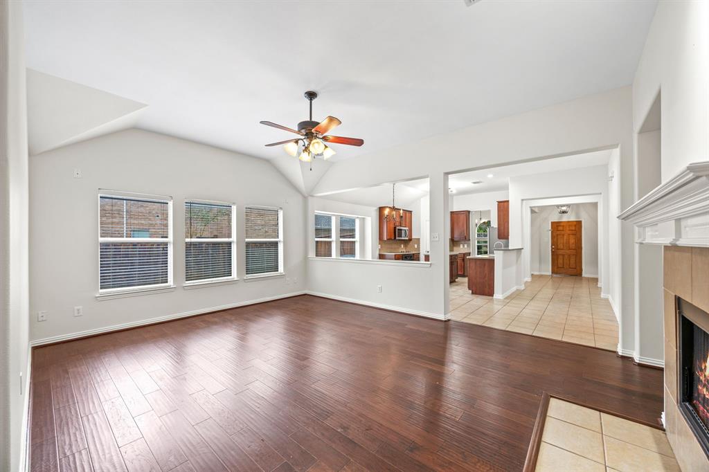 2804 Barco Grand Prairie, TX 75054 - Photo 9 of 25 a view of an empty room with wooden floor and a window