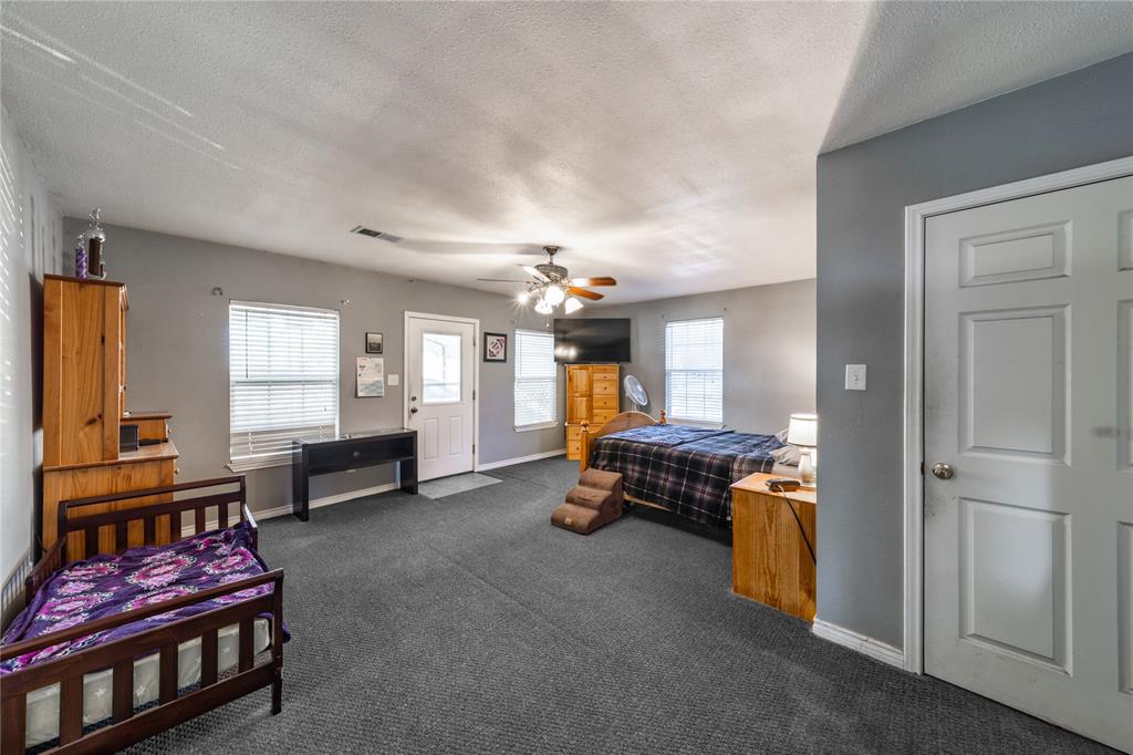 10 Carter Road Van Alstyne, TX 75495 - Photo 14 of 37 a bedroom with furniture and a chandelier