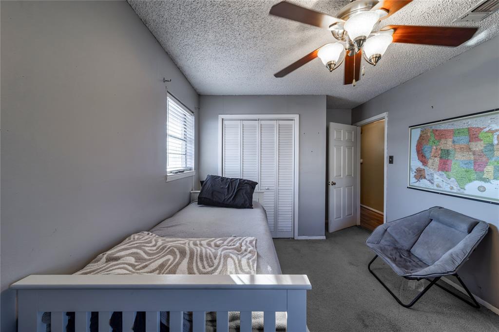 10 Carter Road Van Alstyne, TX 75495 - Photo 23 of 37 a bedroom with a bed and a chandelier