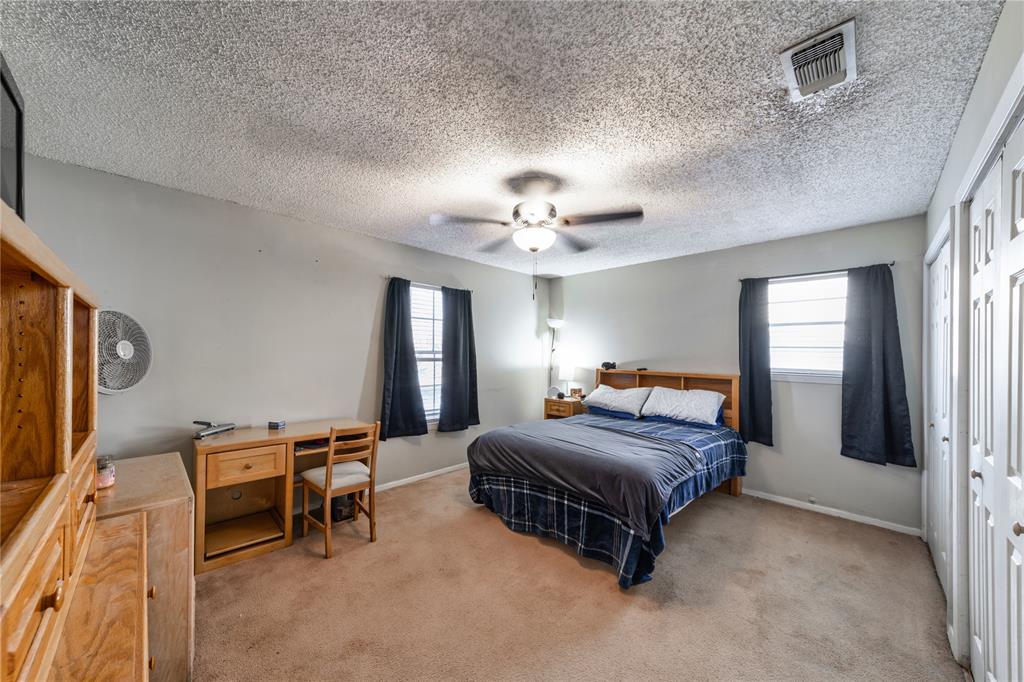 10 Carter Road Van Alstyne, TX 75495 - Photo 24 of 37 a bedroom with a bed and a chandelier