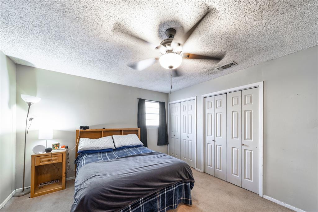 10 Carter Road Van Alstyne, TX 75495 - Photo 25 of 37 a bedroom with a bed and a chandelier
