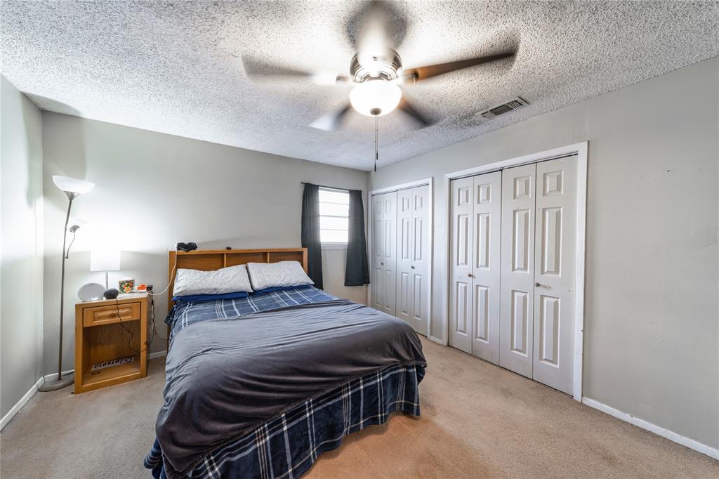 10 Carter Road Van Alstyne, TX 75495 - Photo 26 of 37 a bedroom with a bed and a chandelier