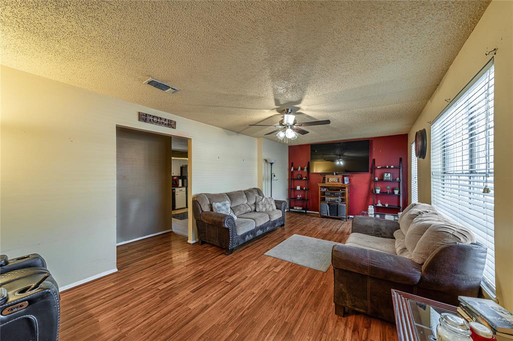 10 Carter Road Van Alstyne, TX 75495 - Photo 3 of 37 a living room with furniture and a wooden floor