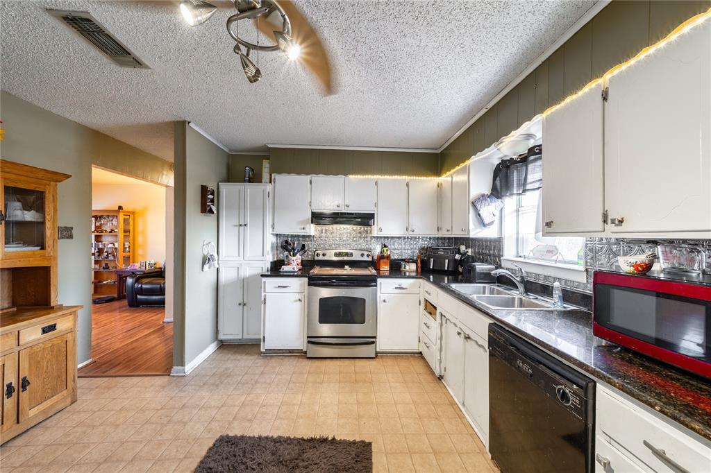 10 Carter Road Van Alstyne, TX 75495 - Photo 10 of 37 a kitchen with a sink stainless steel appliances and cabinets