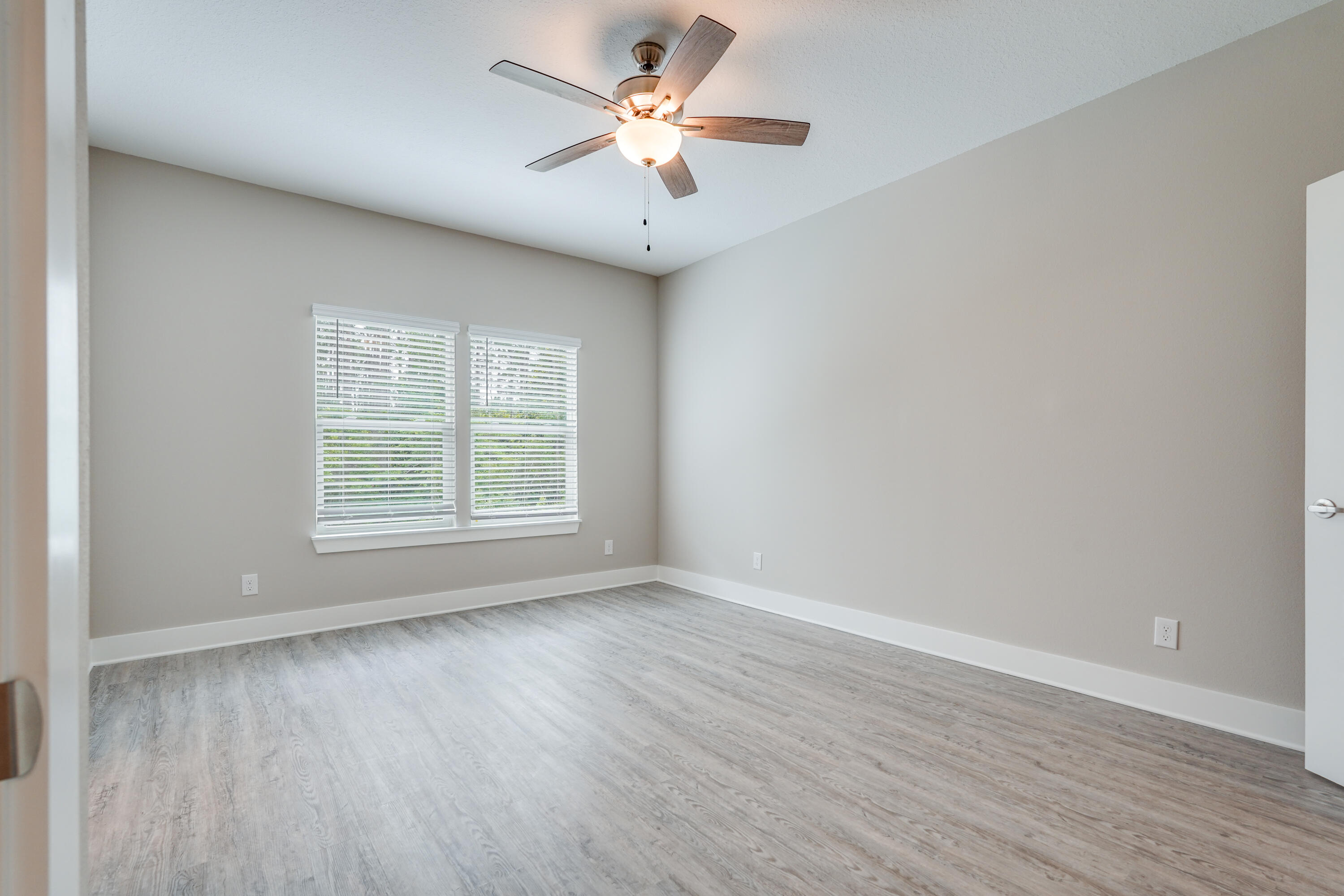 16 Date Palm Lane Freeport, FL 32439 - Photo 5 of 10 wooden floor in an empty room with a window