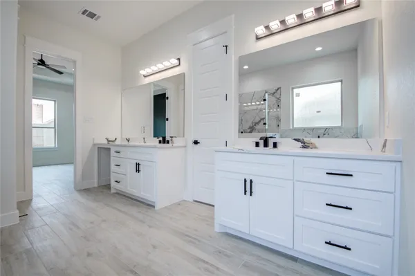 a bathroom with a double vanity sink mirror and double