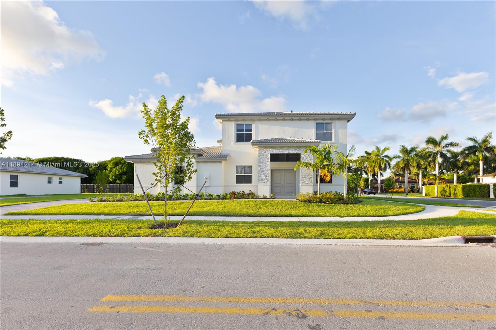 13203 Southwest 188th Terrace, Unit 13203 Miami, FL 33177 - Photo 8 of 49 a view of a house with a swimming pool and a yard