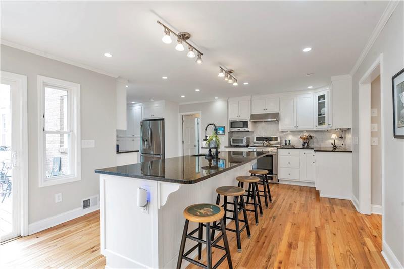 3167 Northbrook Drive Atlanta, GA 30341 - Photo 13 of 41 a kitchen with stainless steel appliances kitchen island granite countertop a table chairs refrigerator and microwave