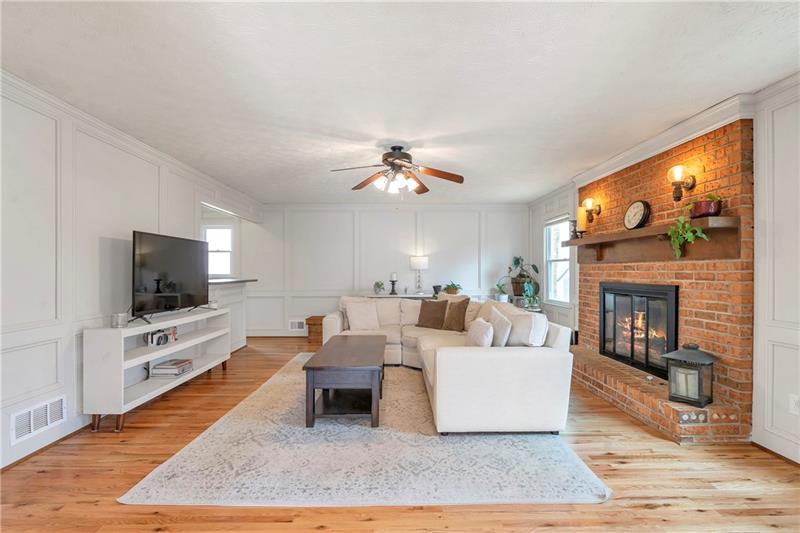 3167 Northbrook Drive Atlanta, GA 30341 - Photo 19 of 41 a living room with furniture a flat screen tv and a fireplace