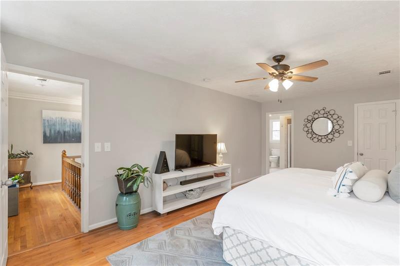3167 Northbrook Drive Atlanta, GA 30341 - Photo 28 of 41 a bedroom with a bed potted plant on dresser and a chandelier