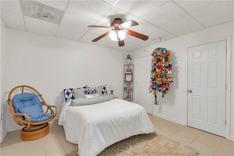 3167 Northbrook Drive Atlanta, GA 30341 - Photo 40 of 41 a bedroom with a bed and a chandelier