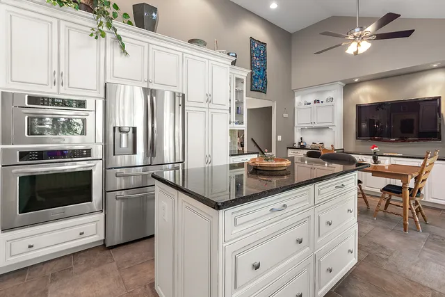 a bathroom with a double vanity sink toilet and a mirror