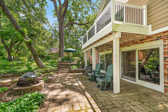 a backyard of a house with table and chairs