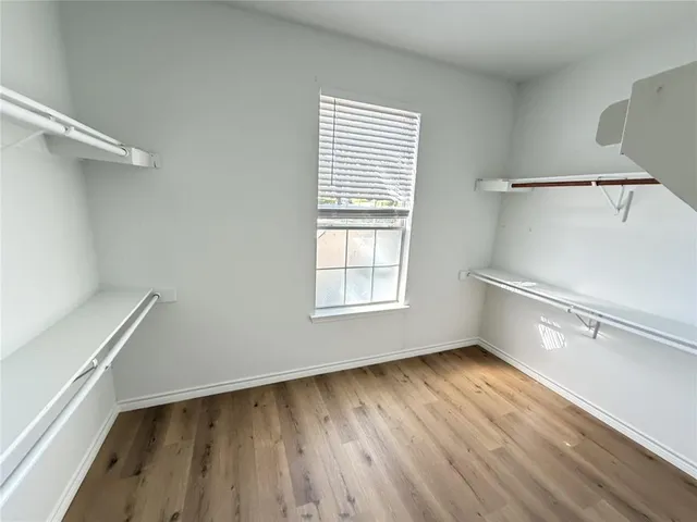 a view of room with window and wooden floor