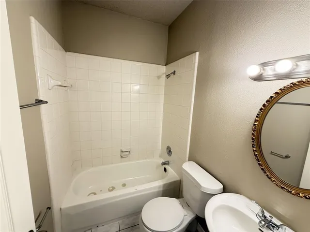 a bathroom with a toilet and a bathtub