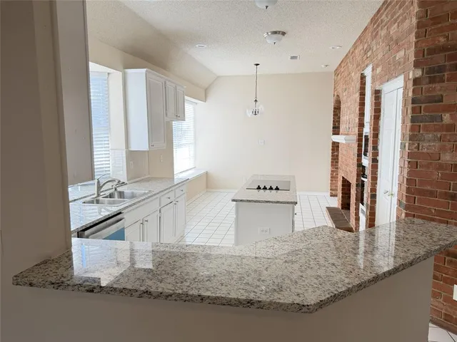 a kitchen with stainless steel appliances granite countertop a sink stove and cabinets