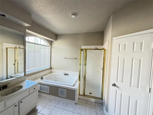 a bathroom with a tub sink and mirror