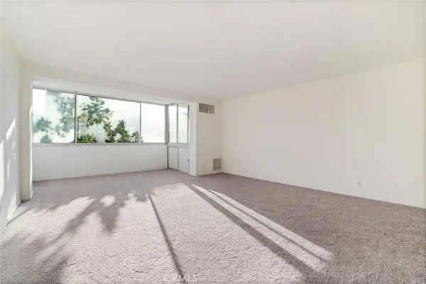 an empty room with large windows