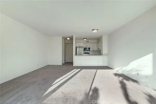 a view of a bedroom with a bed and cabinet