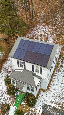 a aerial view of a house with a yard