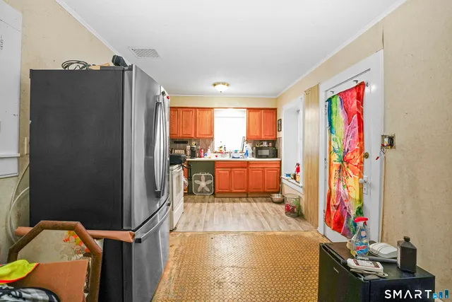 a view of a kitchen with fridge and workspace