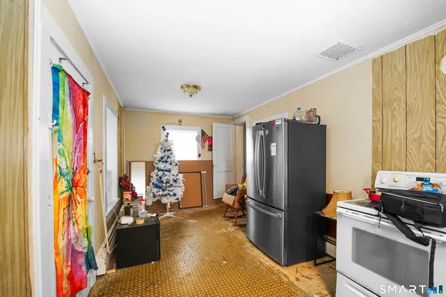 a kitchen with stainless steel appliances granite countertop a refrigerator and a stove