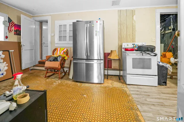 a kitchen with stainless steel appliances granite countertop a refrigerator and a stove top oven