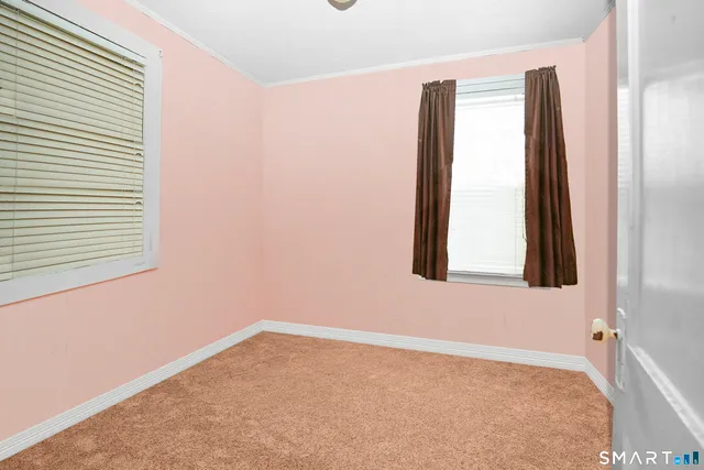 an empty room with windows and closet