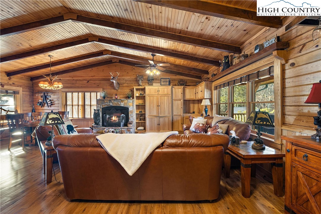 52 Hackett Gragg Road Newland, NC 28657 - Photo 16 of 41 a living room with furniture a fireplace and wooden floor