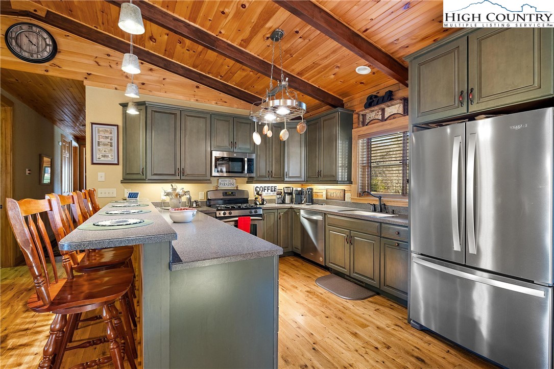 52 Hackett Gragg Road Newland, NC 28657 - Photo 18 of 41 a kitchen with stainless steel appliances granite countertop a refrigerator a stove and a sink