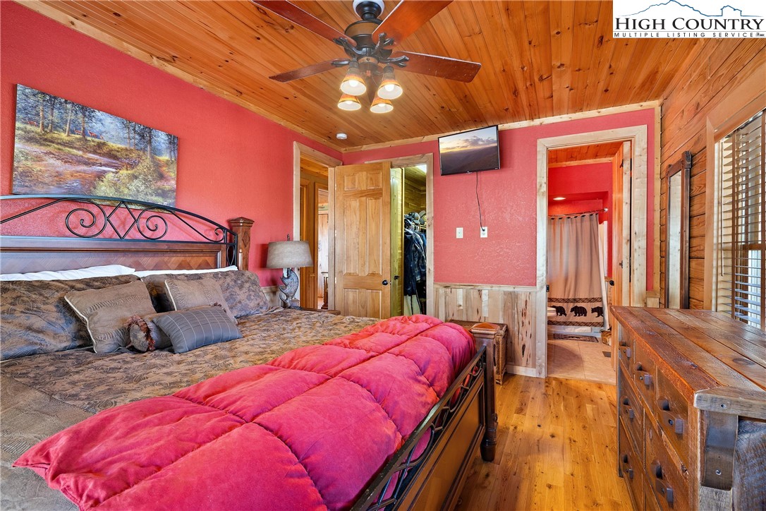 52 Hackett Gragg Road Newland, NC 28657 - Photo 33 of 41 a bedroom with a bed and a chandelier