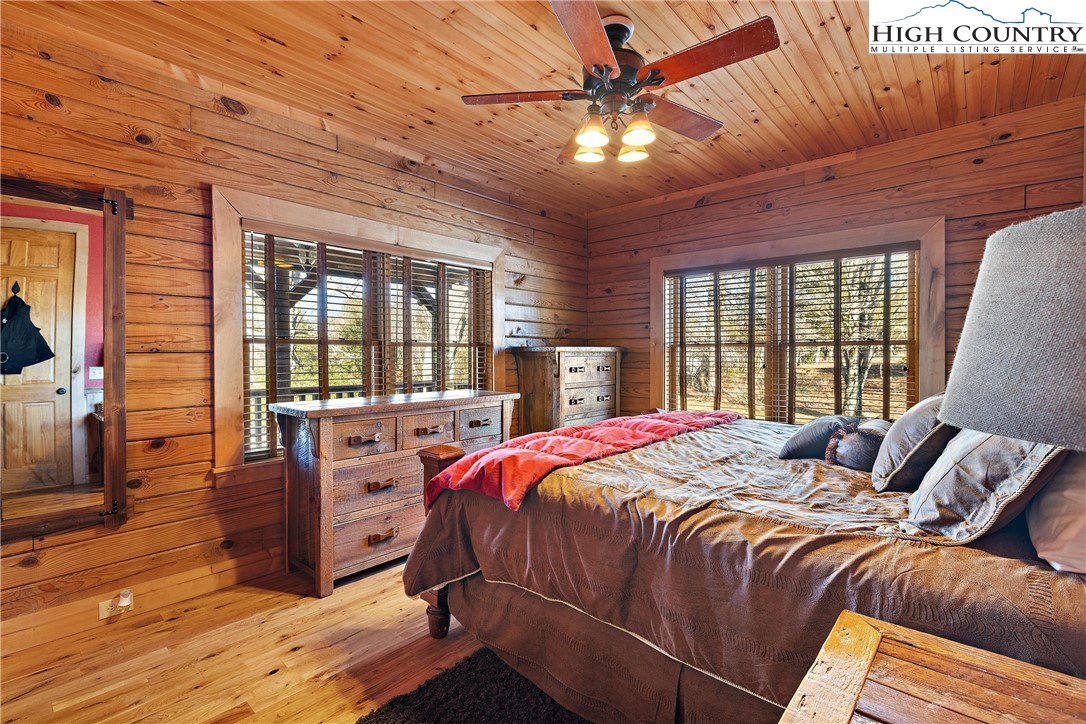 52 Hackett Gragg Road Newland, NC 28657 - Photo 34 of 41 a bedroom with a bed and wooden floor